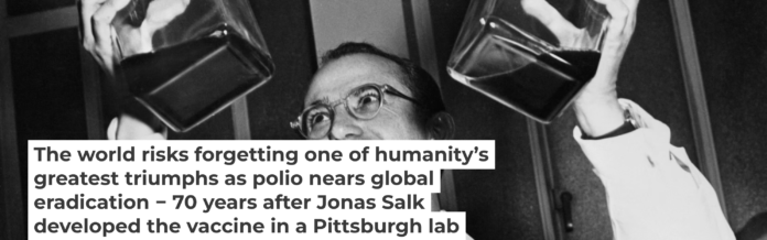 Dr. Jonas Salk displays his polio vaccine, which he developed in a University of Pittsburgh laboratory. Bettmann/Bettmann Collection via Getty Images